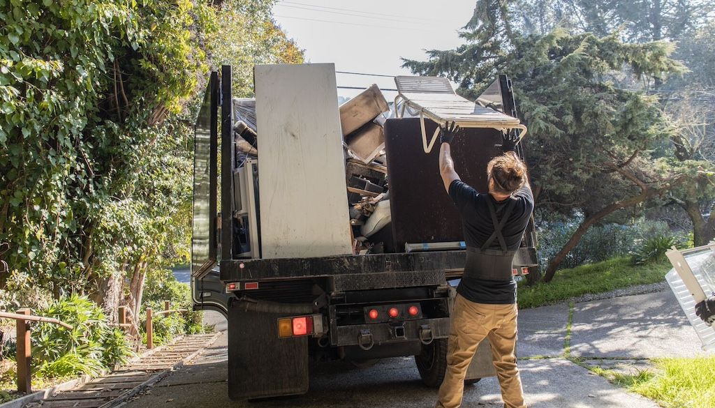 Clutter Cleaners crew loading furniture and junk into a removal truck